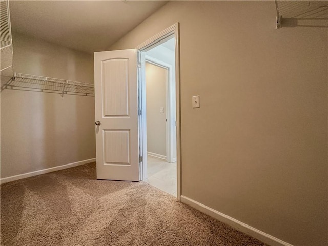 spacious closet with carpet floors