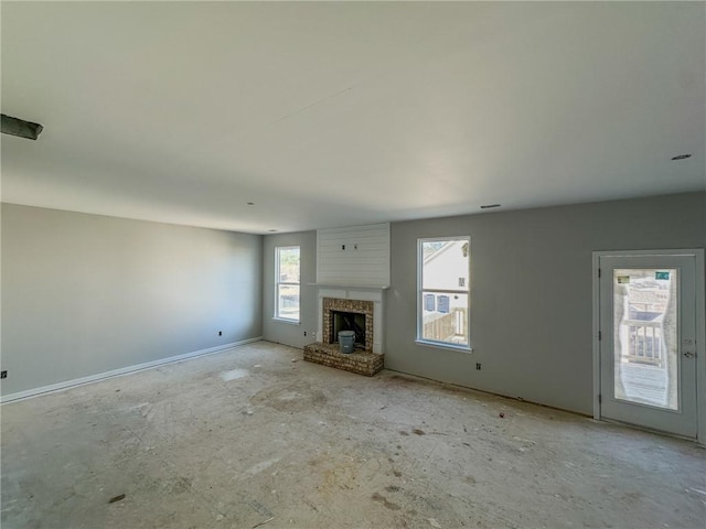 unfurnished living room with a brick fireplace