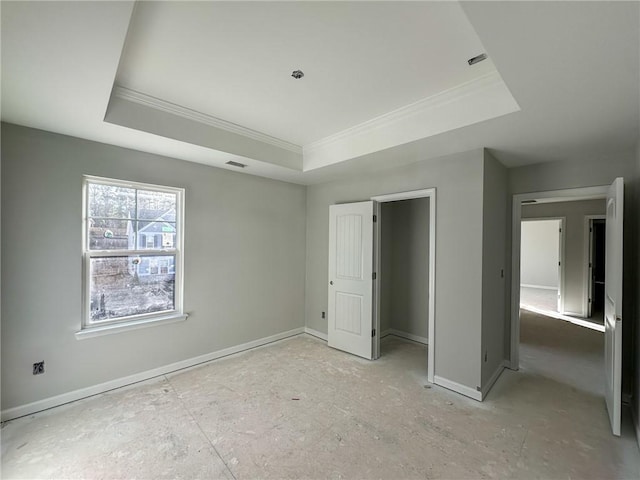 unfurnished bedroom with a raised ceiling and crown molding