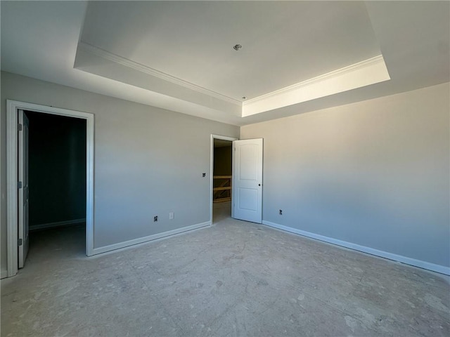 unfurnished room featuring a raised ceiling