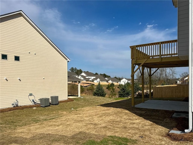 view of yard featuring a residential view, a patio, central AC unit, and fence