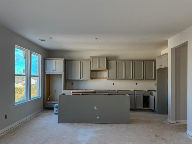 kitchen with a kitchen island and gray cabinets