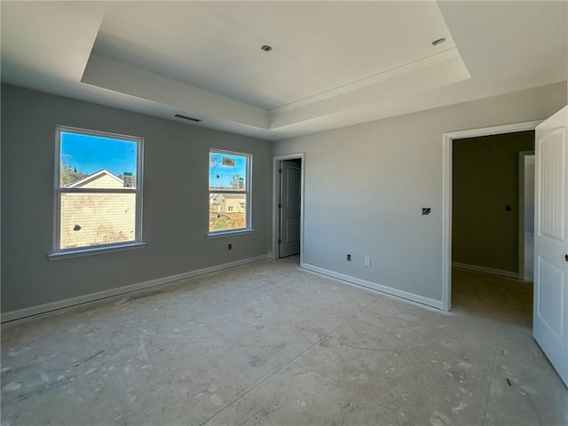 unfurnished bedroom with a tray ceiling