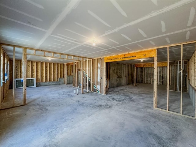 miscellaneous room with unfinished concrete flooring