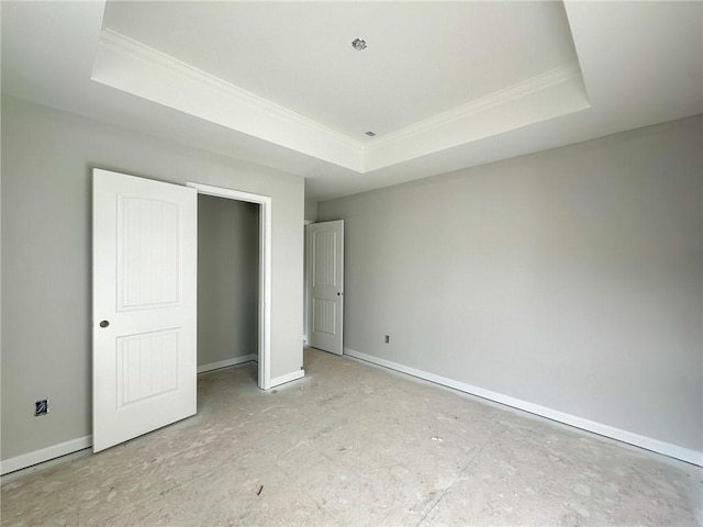 unfurnished bedroom featuring ornamental molding and a raised ceiling