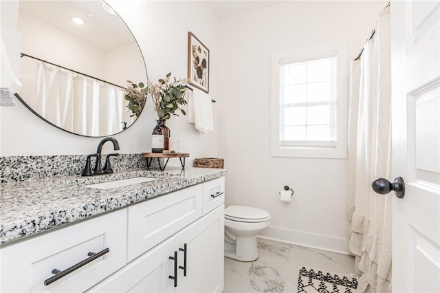 bathroom featuring toilet and vanity