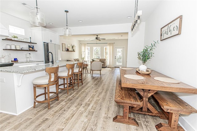 dining area featuring ceiling fan and light hardwood / wood-style flooring