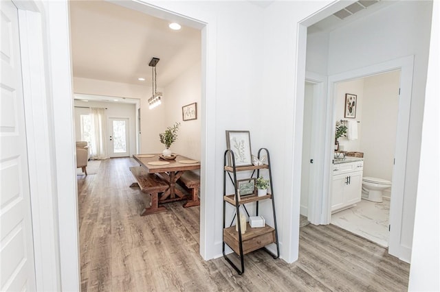 hall with french doors and light hardwood / wood-style floors