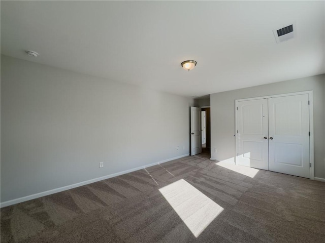 unfurnished bedroom with a closet and carpet