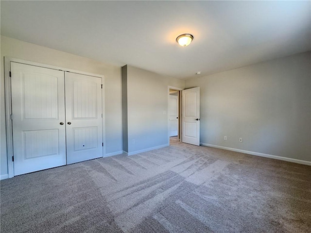 unfurnished bedroom featuring a closet and carpet flooring