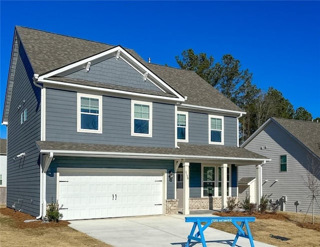 craftsman inspired home featuring covered porch and a garage