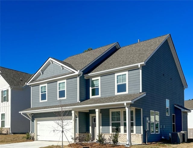 craftsman-style house featuring central AC unit, a garage, and a porch