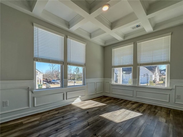 unfurnished room featuring dark hardwood / wood-style floors and beam ceiling