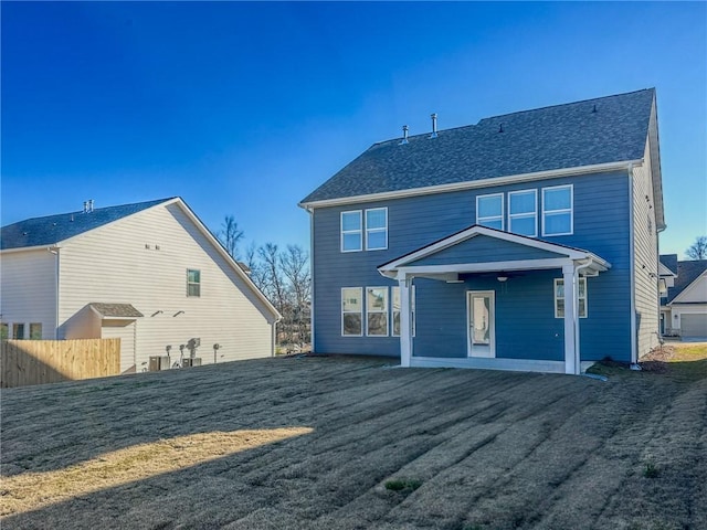 back of house featuring a patio area and a lawn