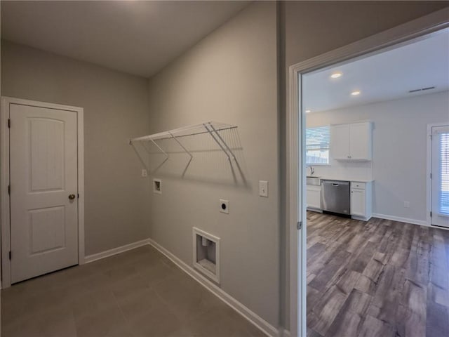 laundry area featuring washer hookup, light hardwood / wood-style flooring, sink, and electric dryer hookup