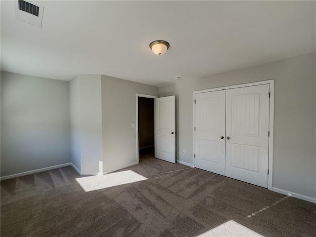 unfurnished bedroom with carpet floors and a closet