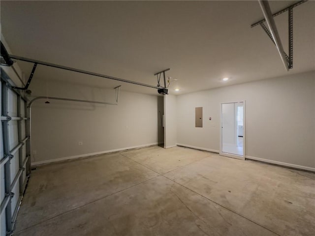 garage with a garage door opener and electric panel