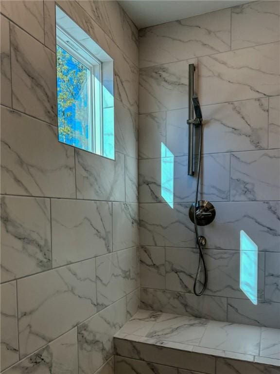 bathroom with tiled shower