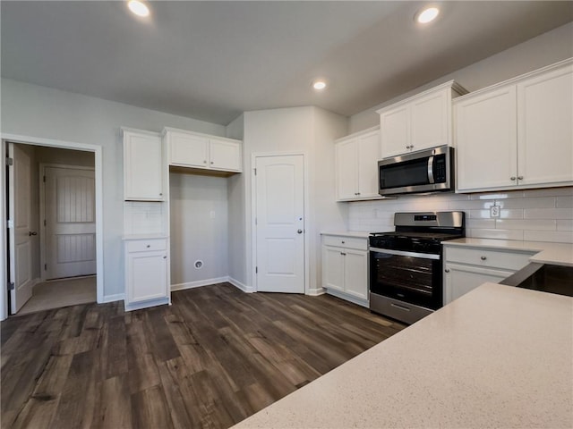 kitchen featuring tasteful backsplash, appliances with stainless steel finishes, dark hardwood / wood-style flooring, and white cabinetry