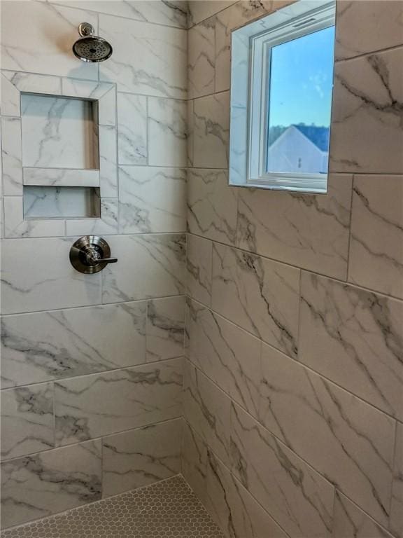 bathroom with a tile shower