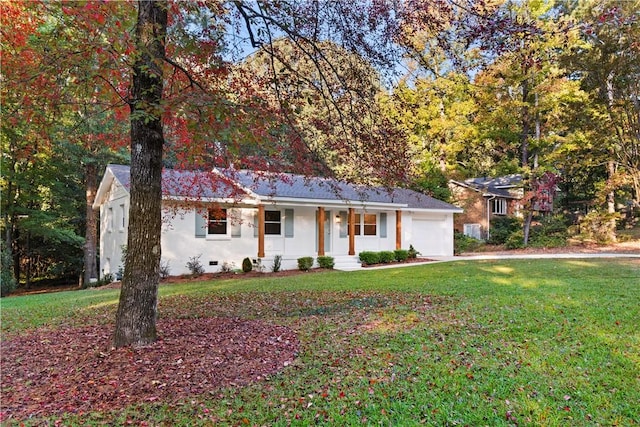 single story home featuring a porch, a front yard, and a garage