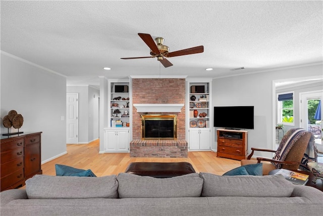 1340 Ferndale Dr, Auburn, AL 36830 - living area with a textured ceiling, light wood-style floors, ceiling fan, a brick fireplace, and ornamental molding