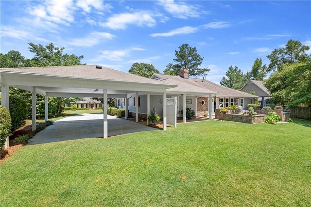 1340 Ferndale Dr, Auburn, AL 36830 - rear view of house with a yard, a chimney, a carport, driveway, and a shingled roof