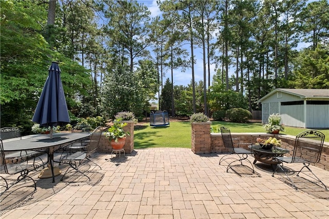 1340 Ferndale Dr, Auburn, AL 36830 - view of patio with an outdoor fire pit, outdoor dining area, and view of scattered trees