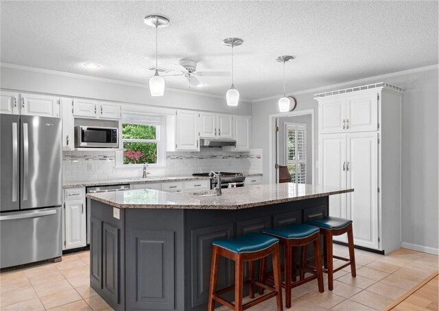 1340 Ferndale Dr, Auburn, AL 36830 - kitchen featuring stainless steel appliances, crown molding, backsplash, under cabinet range hood, and white cabinetry