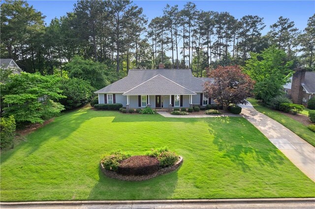 1340 Ferndale Dr, Auburn, AL 36830 - ranch-style house featuring covered porch, a front yard, a chimney, concrete driveway, and a shingled roof