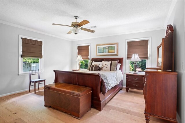 1340 Ferndale Dr, Auburn, AL 36830 - bedroom with crown molding, light wood-type flooring, a textured ceiling, and a ceiling fan
