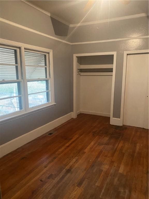 unfurnished bedroom featuring dark hardwood / wood-style flooring and ornamental molding