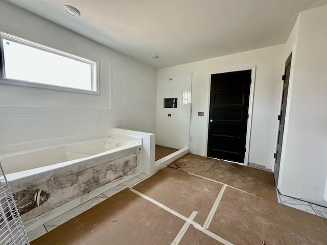 bathroom with a garden tub