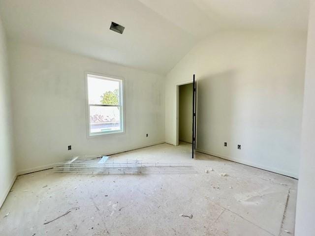 spare room featuring lofted ceiling