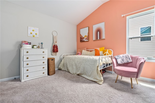 carpeted bedroom featuring baseboards and vaulted ceiling