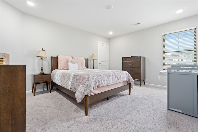 bedroom featuring light carpet, visible vents, recessed lighting, and baseboards