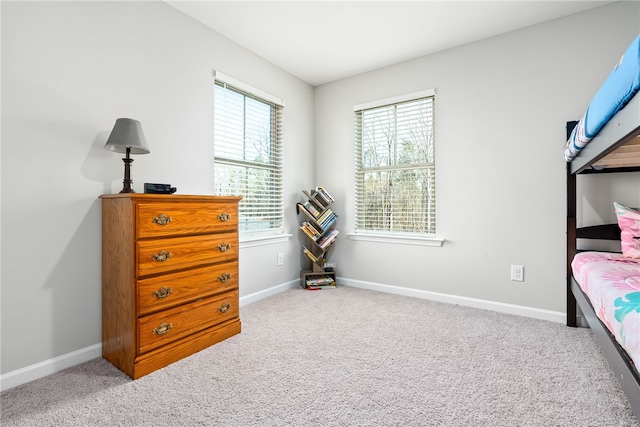 carpeted bedroom with baseboards