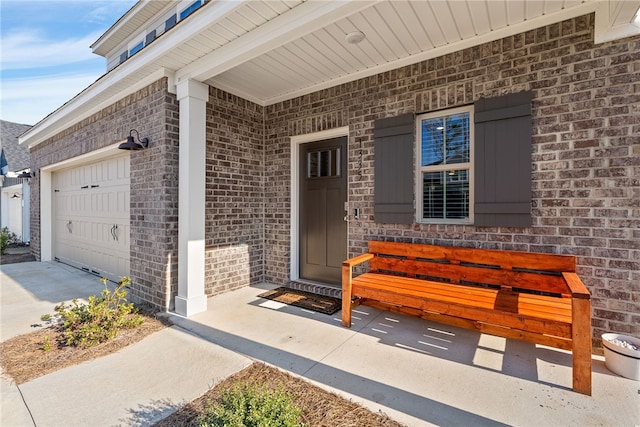 property entrance featuring brick siding and an attached garage