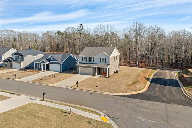 birds eye view of property featuring a view of trees