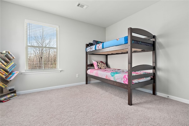 carpeted bedroom with baseboards and visible vents