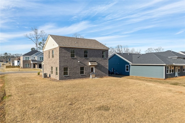 rear view of property with a yard and cooling unit