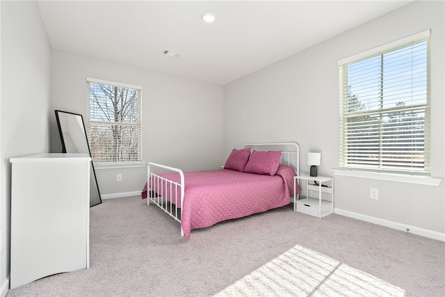 bedroom featuring visible vents, baseboards, and carpet floors