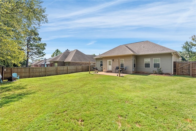 back of house with a lawn and a patio area