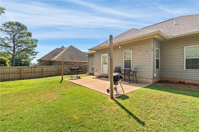 back of house with a yard and a patio