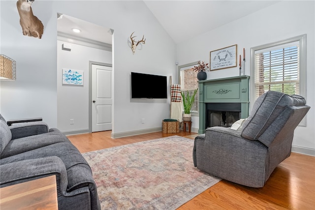 living room featuring light hardwood / wood-style flooring and vaulted ceiling