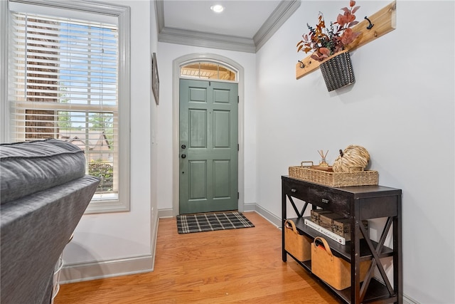 foyer with hardwood / wood-style floors and crown molding