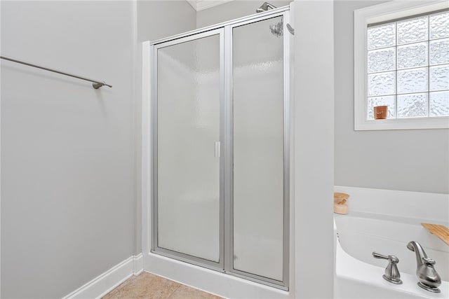 bathroom featuring tile patterned flooring and independent shower and bath