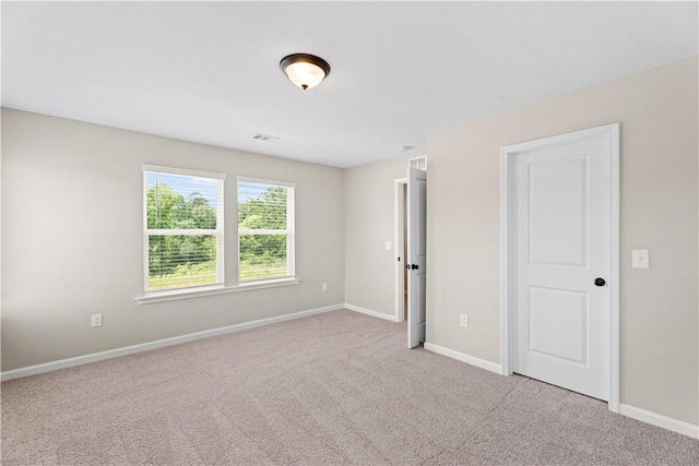 unfurnished room featuring baseboards, carpet, and visible vents