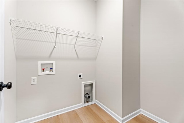 laundry room with laundry area, light wood-style floors, hookup for a washing machine, baseboards, and hookup for an electric dryer