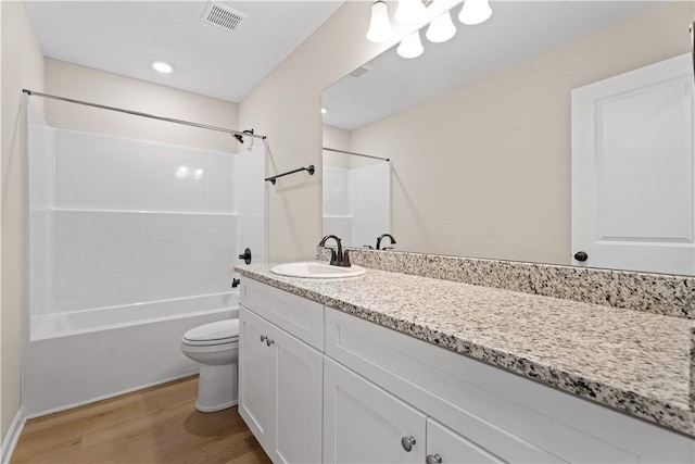 full bathroom with visible vents, bathtub / shower combination, wood finished floors, vanity, and toilet